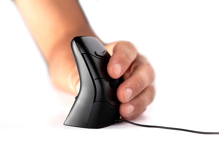 Person using an ergonomic vertical mouse on a white surface, improving comfort and reducing strain.