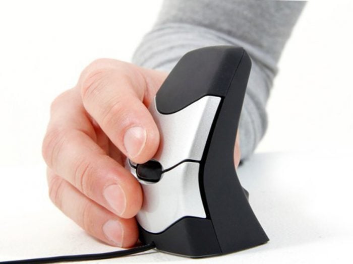 Ergonomic vertical mouse in hand for comfortable computing and reducing wrist strain.