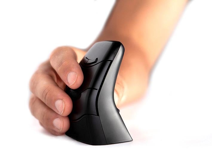 Person using an ergonomic vertical mouse on a white surface, improving comfort and reducing strain.