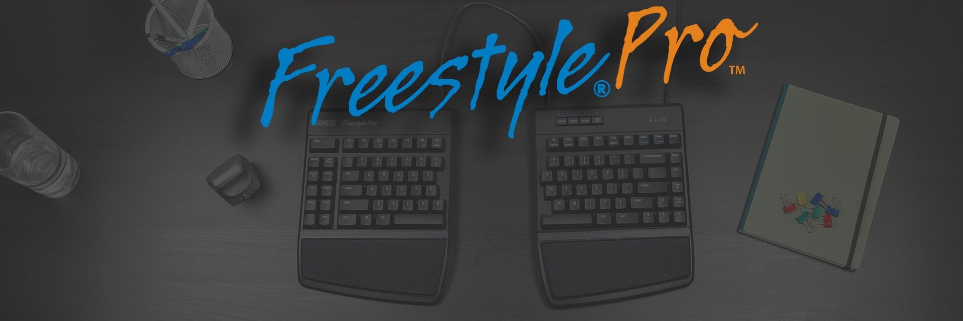 Freestyle Pro Getting Started Freestyle Pro ergonomic keyboard on a desk with a notebook, pens, and glass, emphasizing versatile workspace setup.