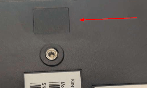 Back panel of electronic device with a visible screw, textured area, and barcode label.
