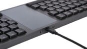 Modern black keyboard with built-in touchpad and USB cable connection, ideal for efficient computer workspaces.