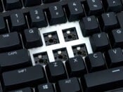 Mechanical keyboard close-up, showcasing removed keys and visible switches for easy customization and repair.