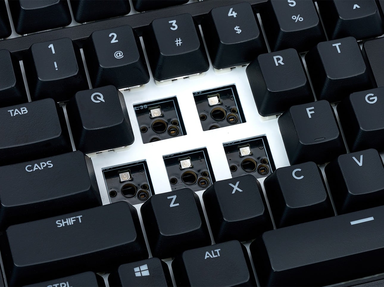 Mechanical keyboard close-up, showcasing removed keys and visible switches for easy customization and repair.