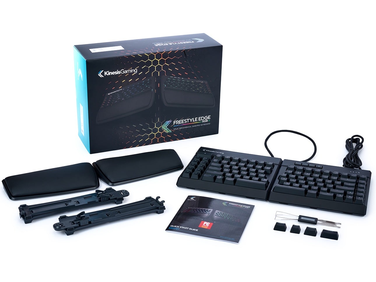 Kinesis Freestyle Edge RGB split mechanical gaming keyboard with accessories and packaging visible on a white background.