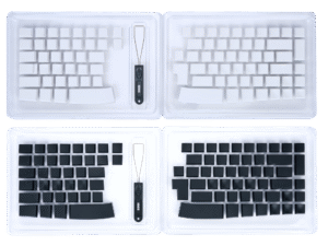 White and black keyboard keycap sets with wire keycap puller on a transparent tray.
