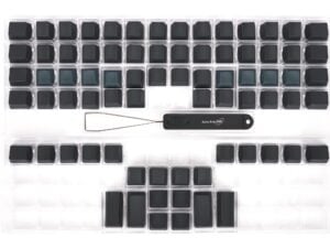 Ergonomic keyboard keycaps with Advantage 360 tool. Black keycaps arranged neatly on a transparent tray.