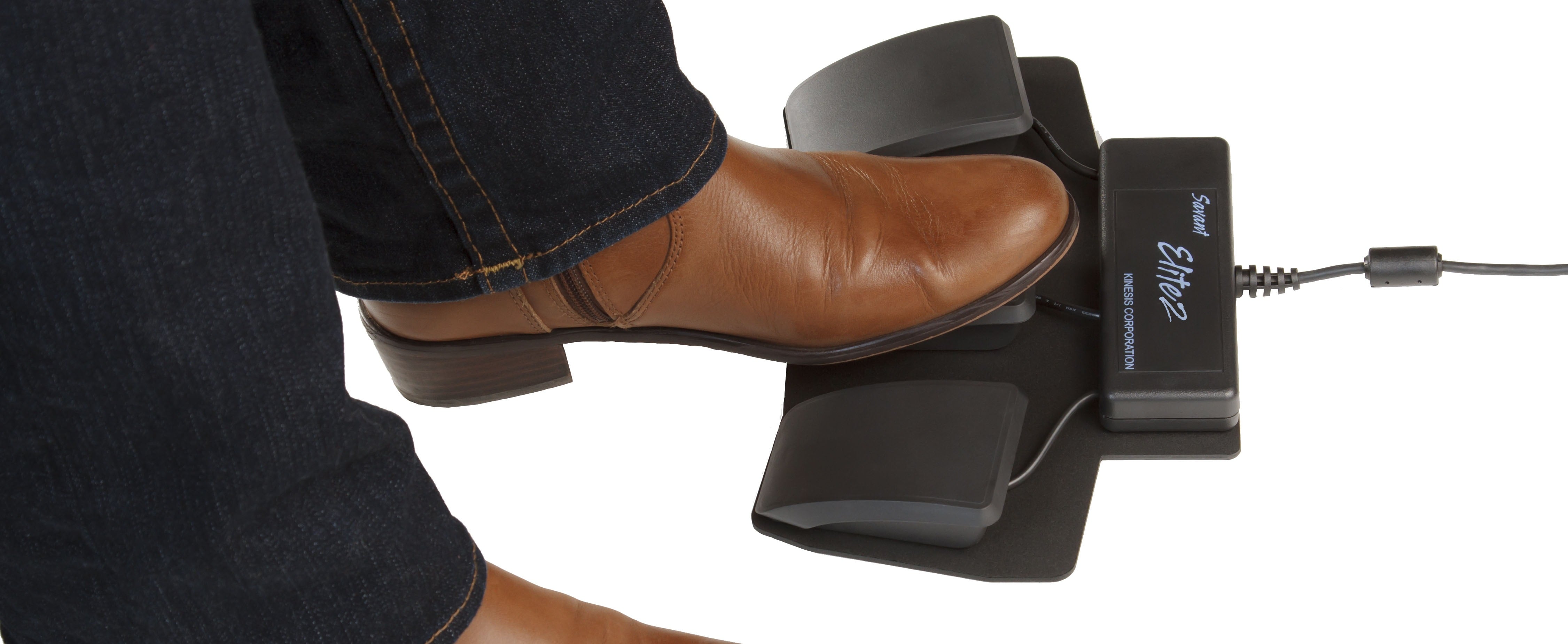Brown shoe pressing foot pedal of a Savant Elite2 USB device for hands-free computing efficiency.
