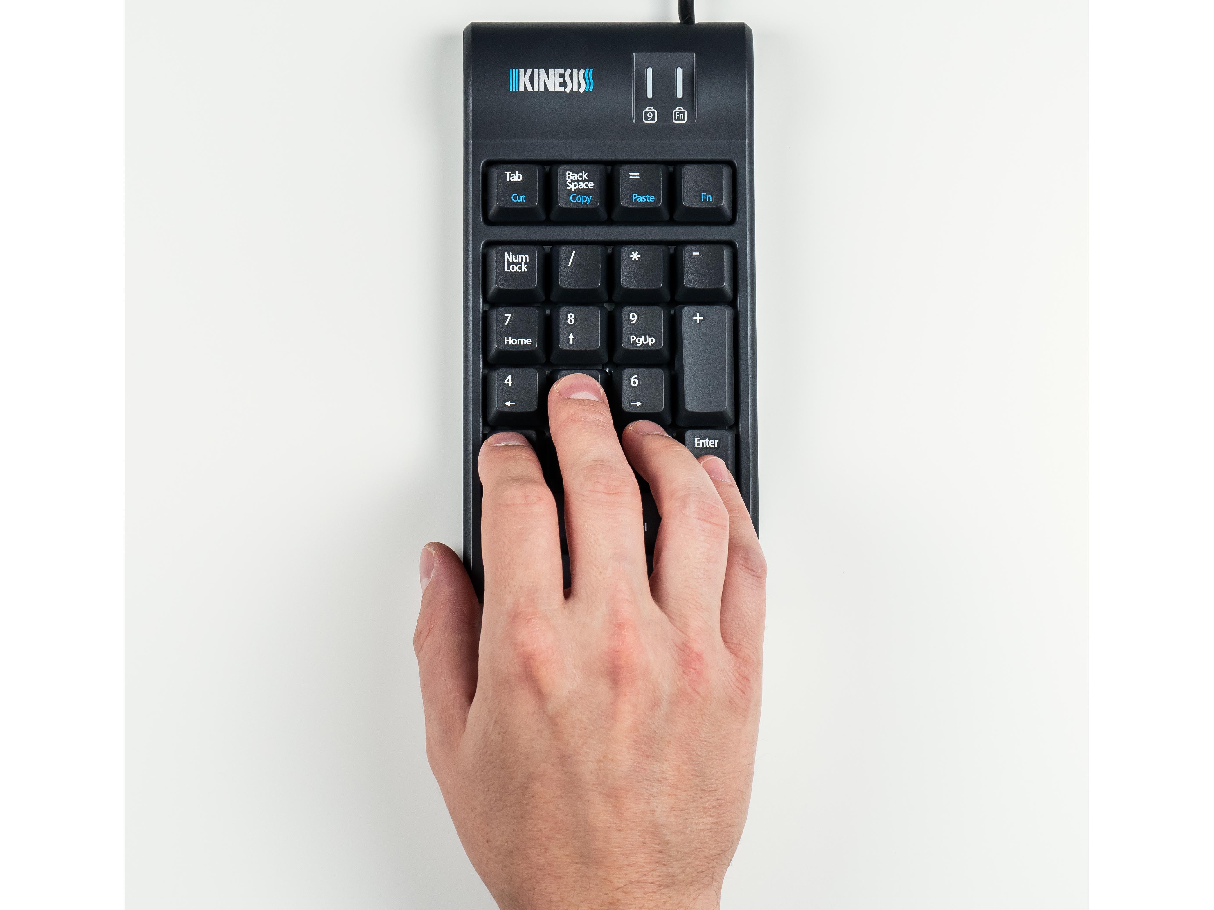 Hand typing on a Kinesis numeric keypad on a white background.