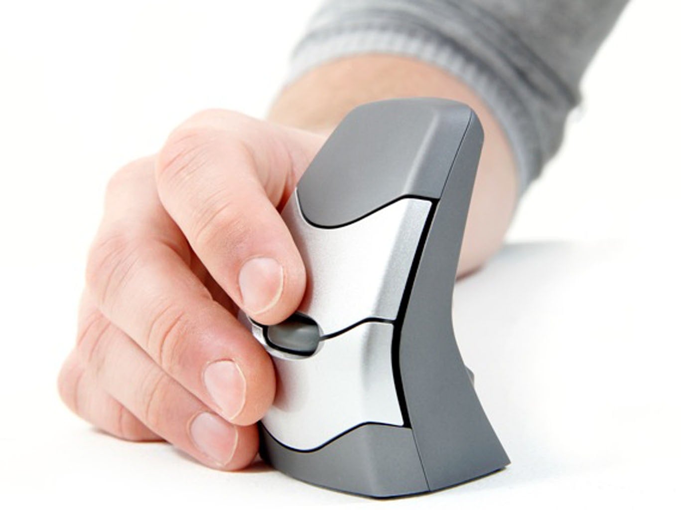 Person using a vertical ergonomic mouse for wrist comfort and improved computer navigation.