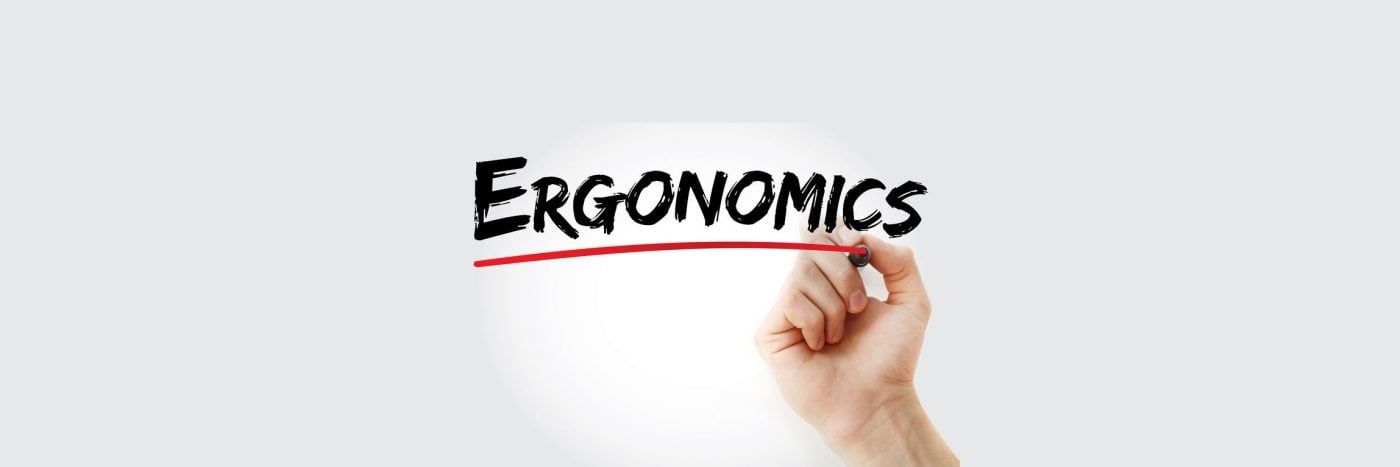 Hand writing Ergonomics with a red underline, emphasizing workplace comfort and efficiency.