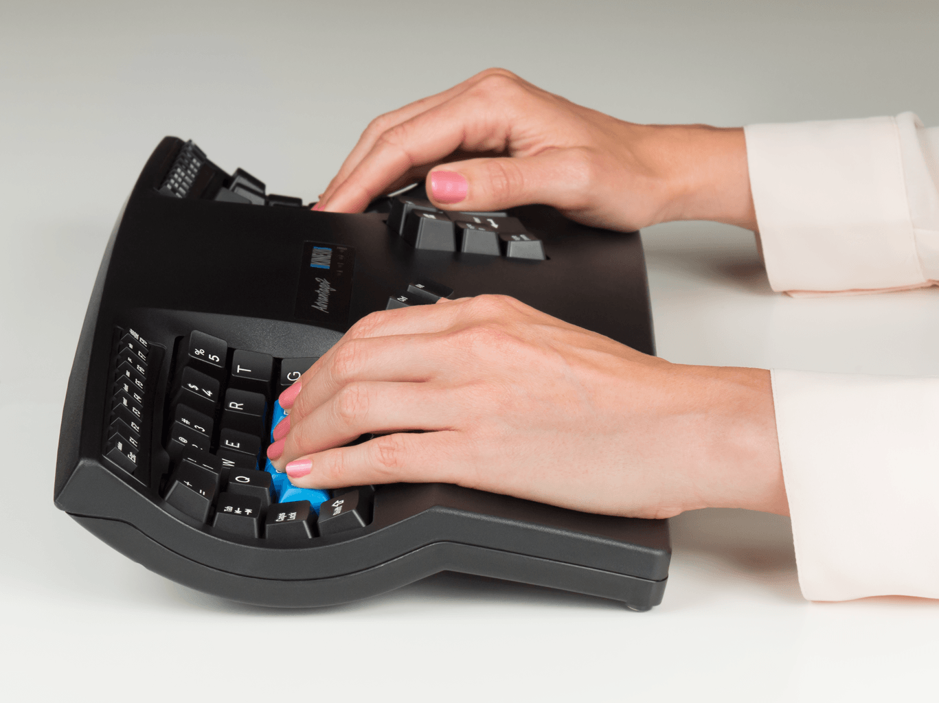 Hands typing on an ergonomic split keyboard for comfortable and efficient computer use.