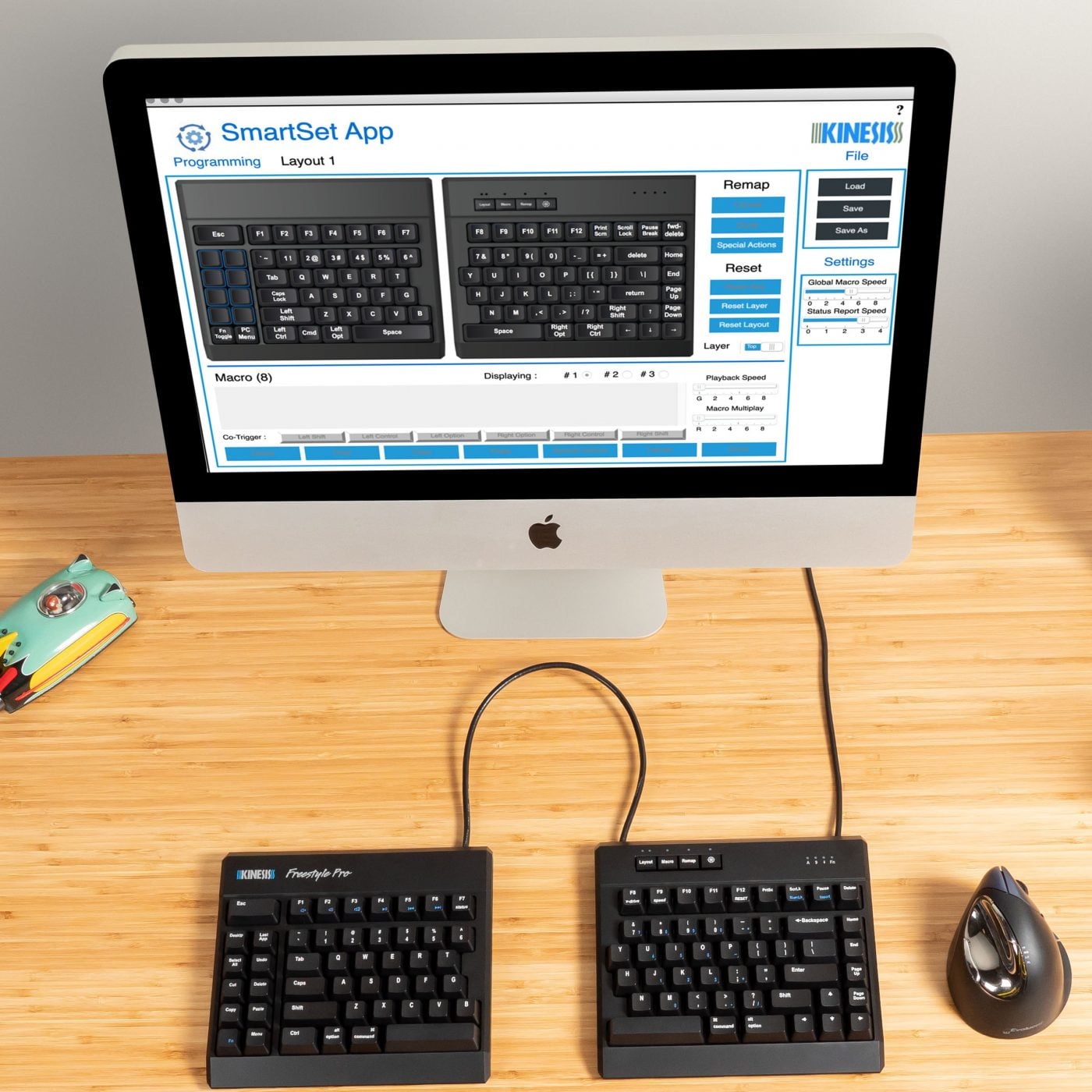 Dual keyboard setup with SmartSet app on a desktop for custom programming, displaying layout options.
