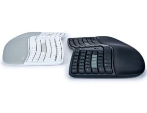 Ergonomic split keyboards in white and black, designed for comfortable typing and wrist support.
