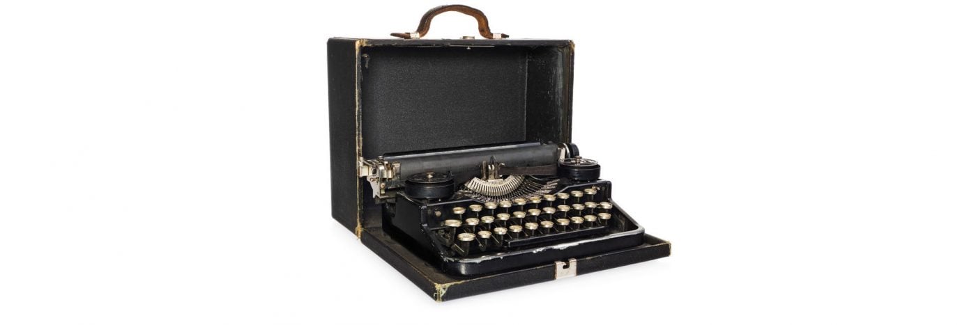 Vintage typewriter in a black case, showcasing retro design and classic keys. Perfect for writing enthusiasts.