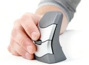 Person using an ergonomic vertical mouse on a white surface, improving comfort and reducing strain.
