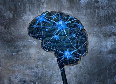 Illustration of a human brain with glowing blue neural network on a textured gray background.