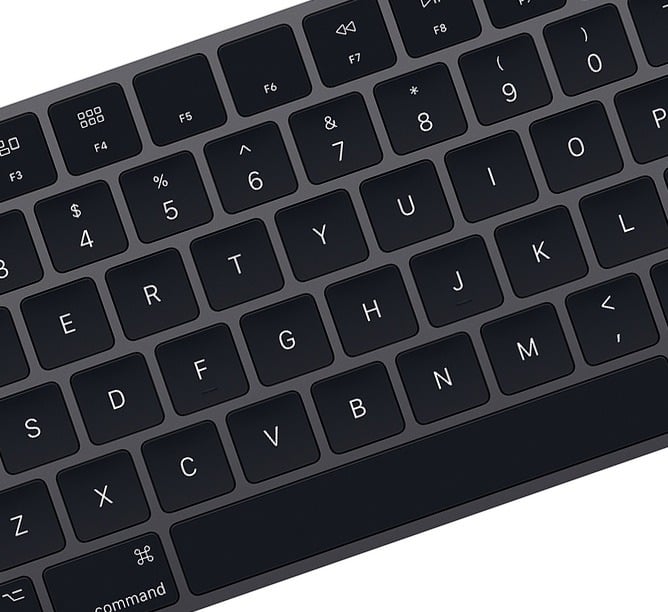 Close-up of a sleek black keyboard with visible letters and function keys, angled view. Perfect for tech-focused content.